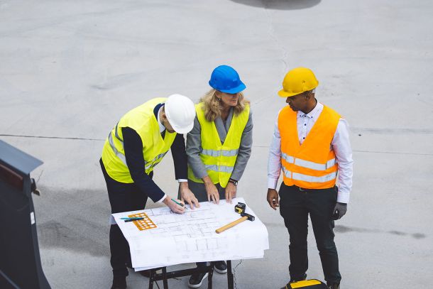 planning colleagues in looking at blueprints