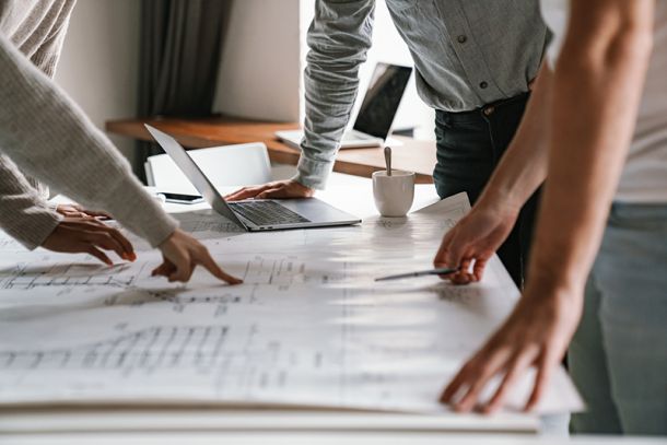 planning colleagues in looking at blueprints